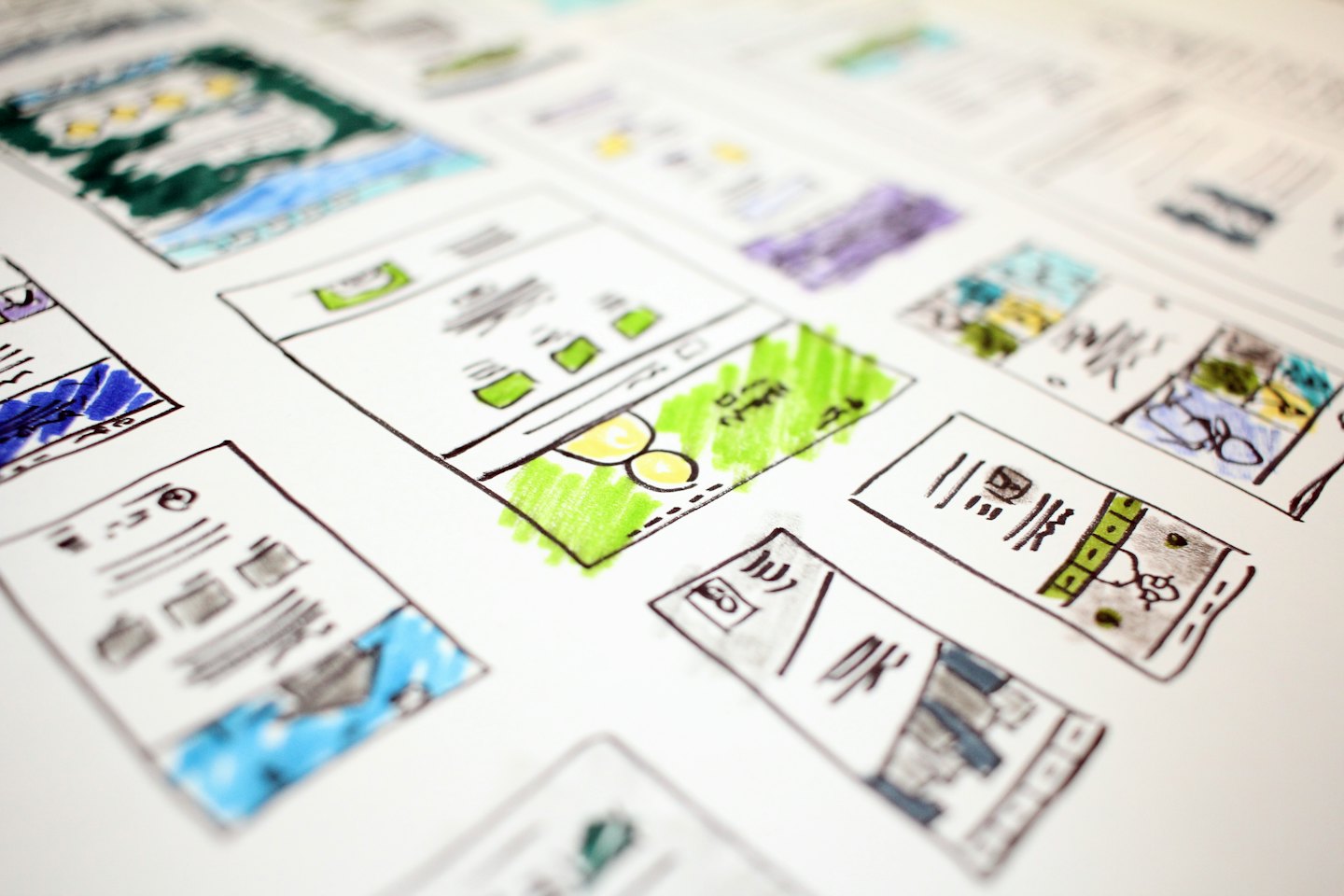 Hand-drawn wireframe sketches of website layouts with colorful markers.